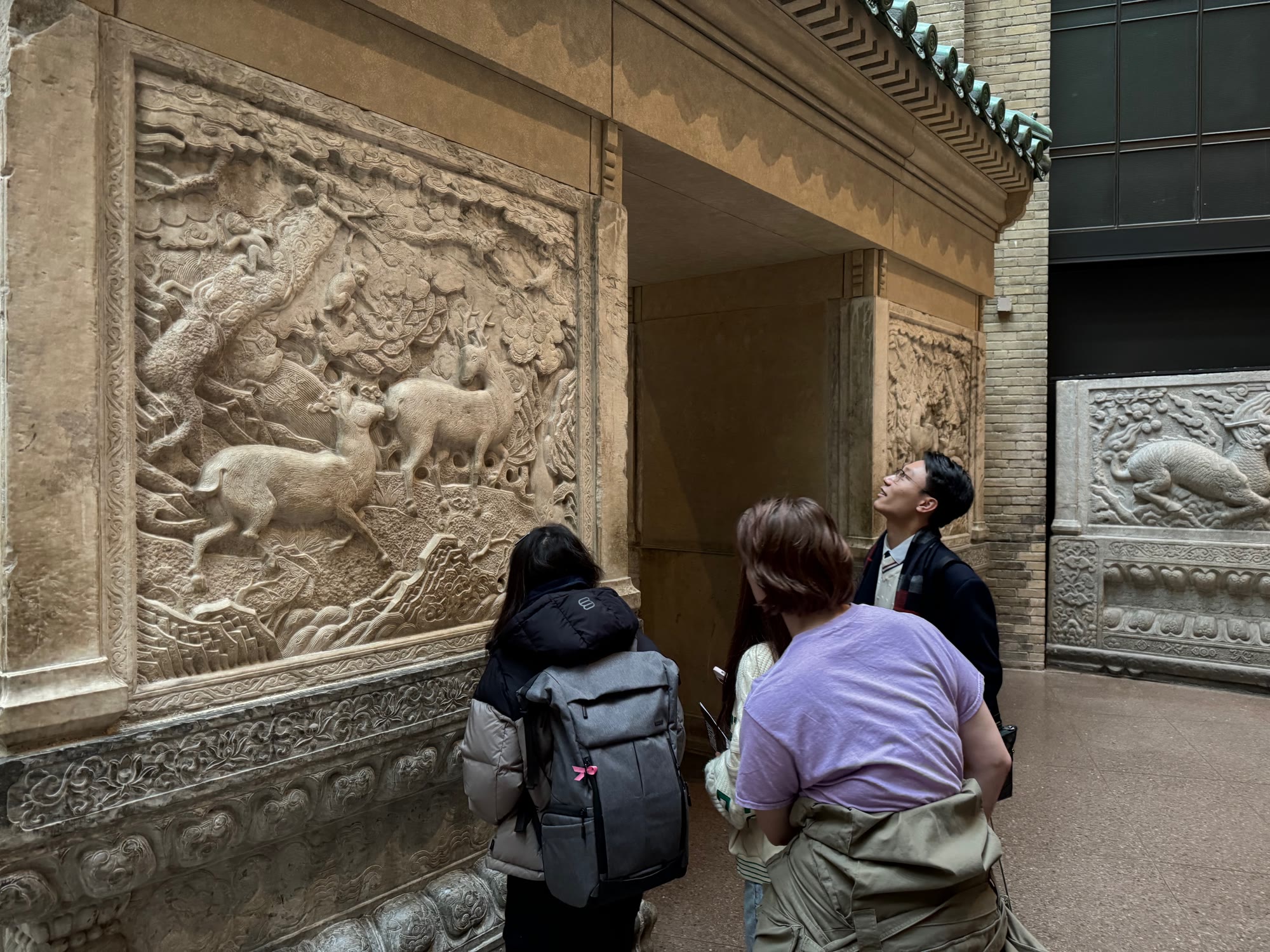 Club members studying carved stone reliefs